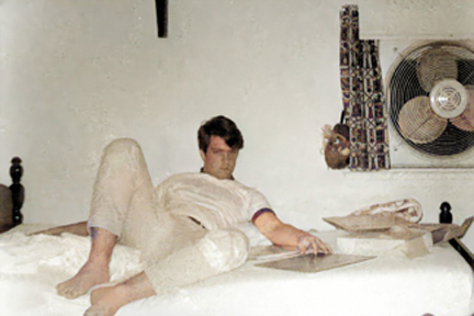 paul lachance on bed in bedroom with fan and coconut