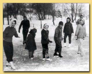 Old picture, from the web, of group skating on a pond in winter